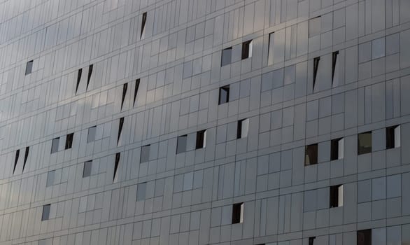 Liverpool, UK - Oct 07, 2023 - Sky reflection on Glass wall of Modern building with Repeating structure. Exterior architecture of building, Copy space, Selective focus.