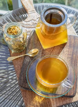 Chinese chrysanthemum flower tea and Dried chrysanthemum flower on wooden cutting board. Healthy beverage for drink. Herbs and medical concept. Space for text, Selective focus.