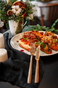 Eclairs on a marble plate on a background with Christmas or New Year decor. High quality photo