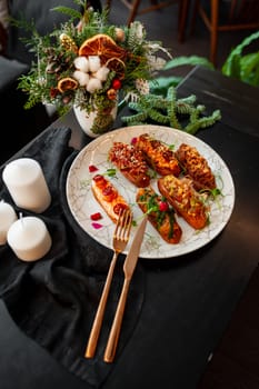 Eclairs on a marble plate on a background with Christmas or New Year decor. High quality photo