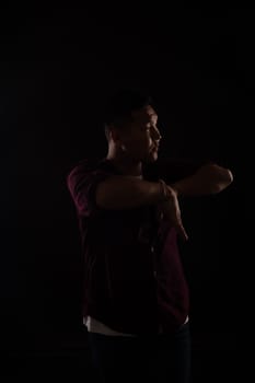 A man dancing in the dark in a studio music