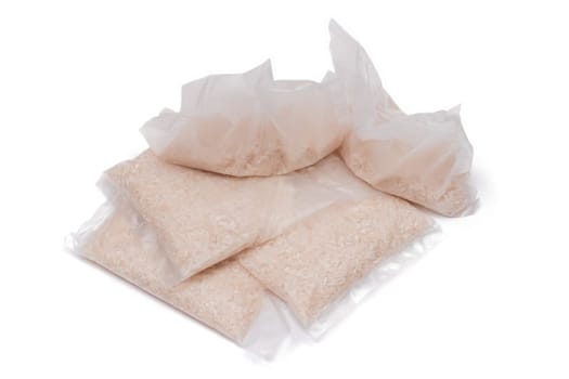 A Plastic Bags of White Long Grain Rice - Isolated on White Background. Small Transparent Packages with Dry Rice - Isolation