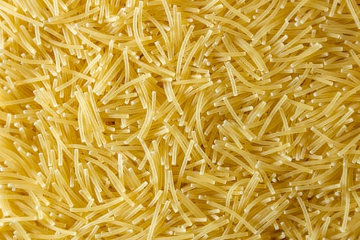 Uncooked Filini Pasta: A Culinary Canvas of Noodles, Creating a Lively and Textured Background for Gourmet Cooking. Dry Pasta. Raw Macaroni - Top View, Flat Lay