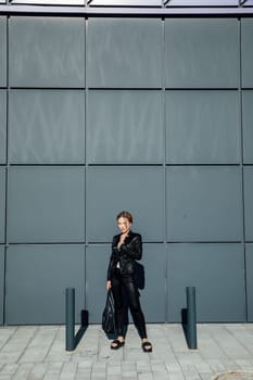 fashionable slender woman walking around the city portrait