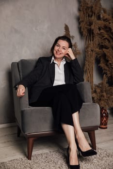 woman in suit at desk in office