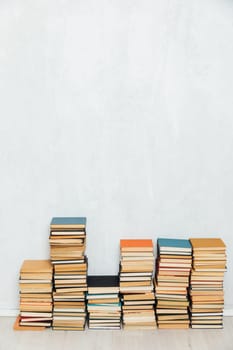 Many Books Piles. Hardback books on wooden table. Back to school. Copy space