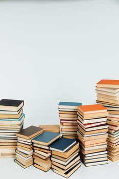 Many Books Piles. Hardback books on wooden table. Back to school. Copy space