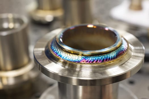 Close-up Freshly welded seam on a stainless flange. Production of metal products from stainless steel by welding.