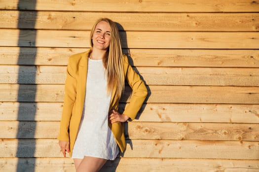 blonde woman in yellow jacket and summer dress