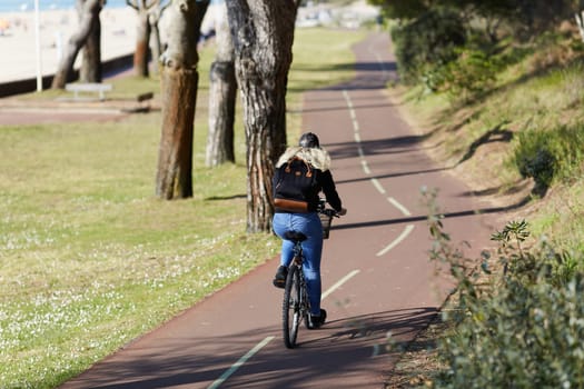 Person riding a bicycle on a cycle path a sunny day