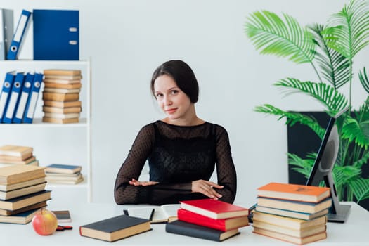 Woman in suit sitting at table in business office