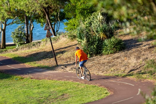 Person riding a bicycle on a cycle path a sunny day