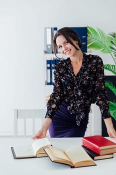 Woman in suit standing at table in business office