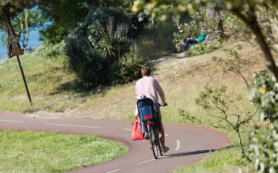 Person riding a bicycle on a cycle path a sunny day