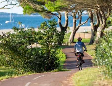 Person riding a bicycle on a cycle path a sunny day