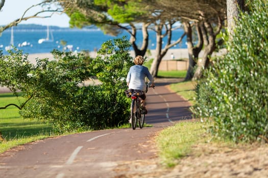 Person riding a bicycle on a cycle path a sunny day