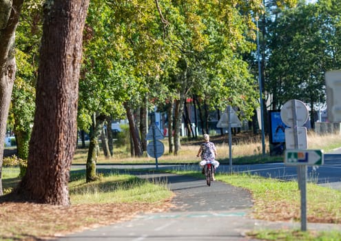 Person riding a bicycle on a cycle path a sunny day