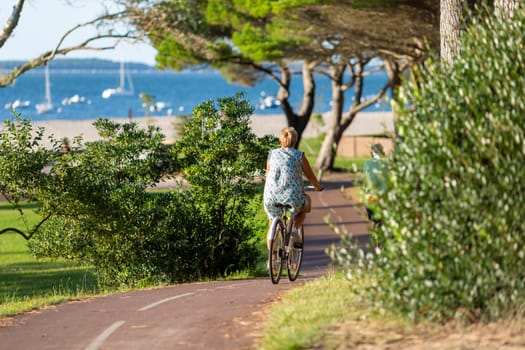 Person riding a bicycle on a cycle path a sunny day