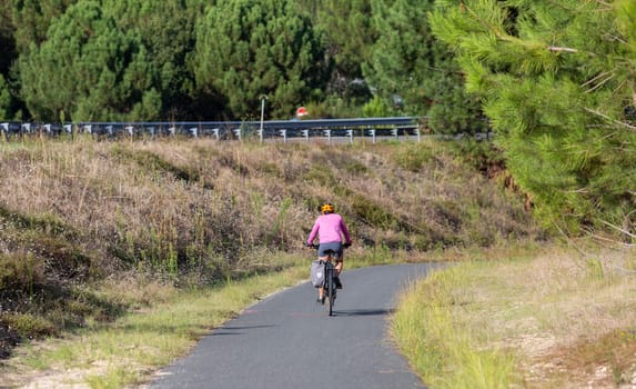 Person riding a bicycle on a cycle path a sunny day