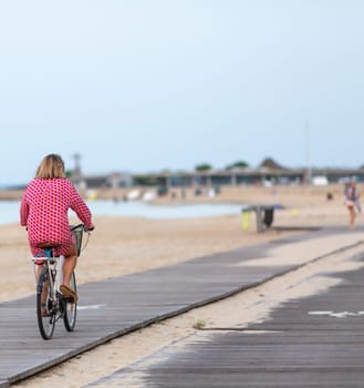 Person riding a bicycle on a cycle path a sunny day