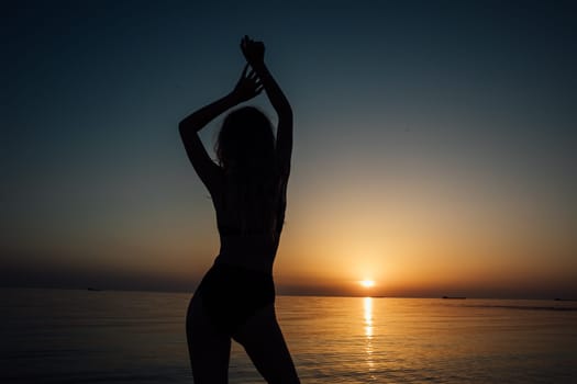 Silhouette of slender woman near the sea