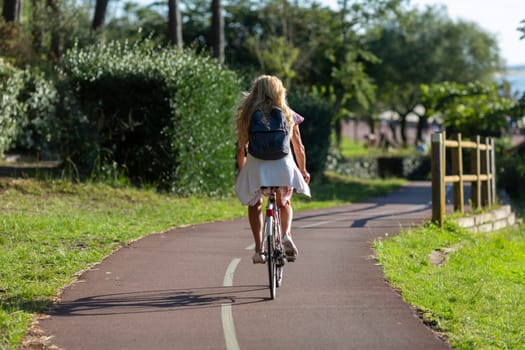Person riding a bicycle on a cycle path a sunny day