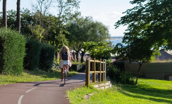 Person riding a bicycle on a cycle path a sunny day