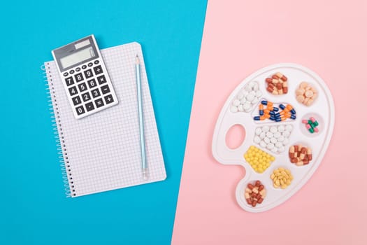 Global Pharmaceutical Industry and Treatment Costs - Different Colored Pills, Tablets and Capsules on White Art Palette with Calculator and Notepad Lying on Split Blue and Pink Background, Flat Lay