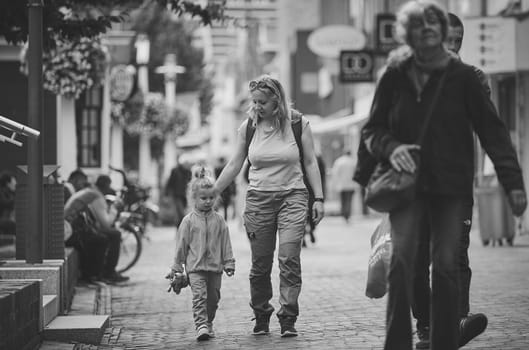 Zaandam, Netherlands, August 29, 2023: Mom and daughter walk in the city