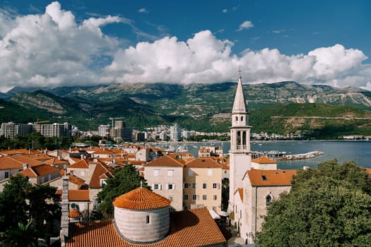 Church of the Holy Trinity near St. John Cathedral among old houses with red roofs. Budva, Montenegro. High quality photo