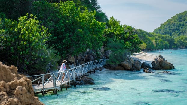 Asian woman on a day trip to Ko Kham Island Sattahip Chonburi Samaesan Thailand a tropical Island in Thailand with a blue ocean, woman at the beach of a tropical island