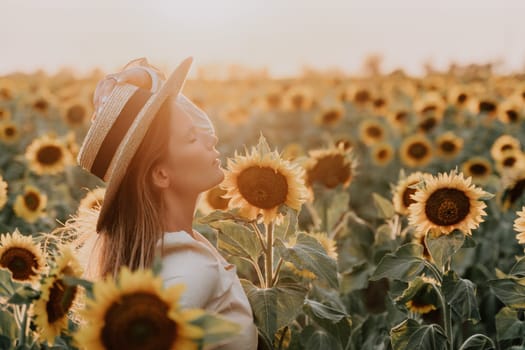 Woman in the sunflowers field. Summer time. Young beautiful woman standing in sunflower field.