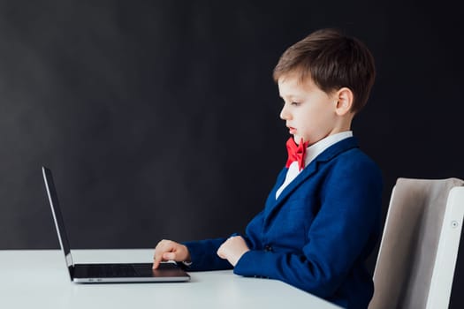 boy in jacket working online at computer
