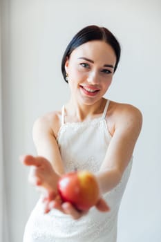 Beautiful fashionable brunette woman and ripe apple for eating