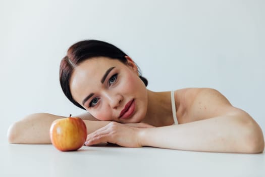 Beautiful fashionable brunette woman and ripe apple for eating