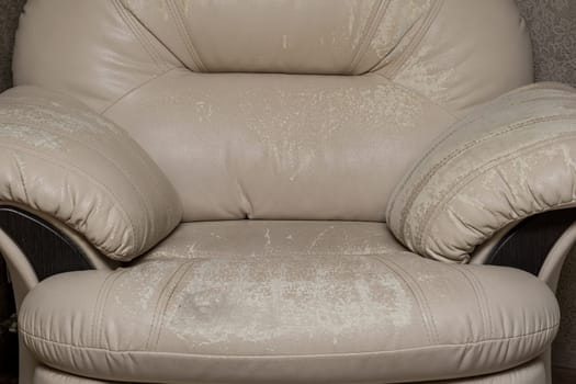 Defects on a white leather sofa. Damaged to leather furniture. Close up of damaged white leather soft tufted furniture. Bad quality leather