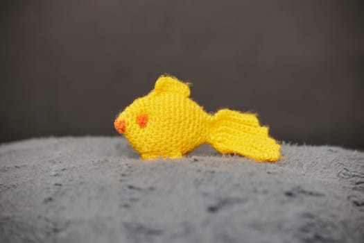 Cute toy knitted fish in the nursery.