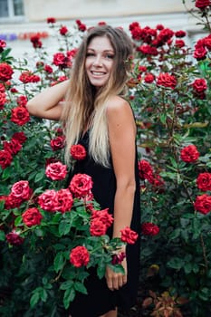 woman in black dress among flowers