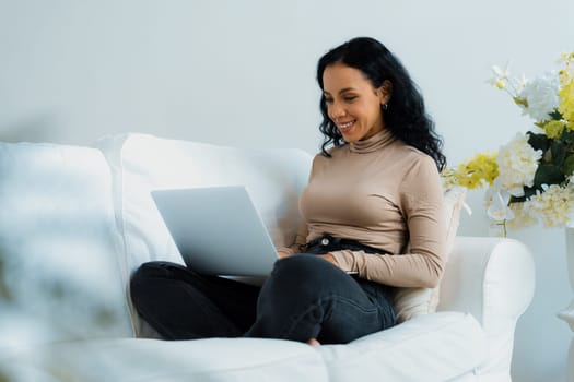 African-American woman using laptop computer for crucial work on internet. Secretary or online content writing working at home.