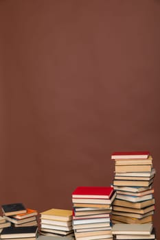 stack of books on brown background library