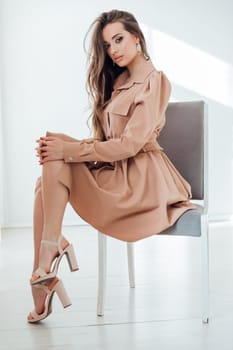 Beautiful woman posing on a chair in a room