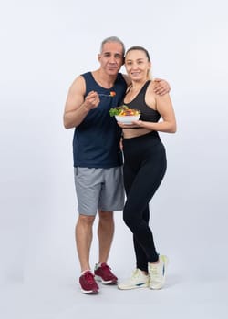 Happy smile senior man and woman portrait holding bowl of vegan fruit and vegetable on isolated background. Healthy senior couple with healthy vegetarian nutrition and body care lifestyle. Clout