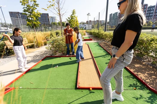 golfers with parents playing golf at sunny day. High quality photo