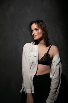Woman posing in a dark room in studio