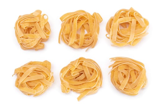 Six Classic Italian Raw Egg Fettuccine - Isolated on White Background. Dry Twisted Uncooked Pasta. Italian Culture and Cuisine. Raw Golden Macaroni Pattern - Isolation