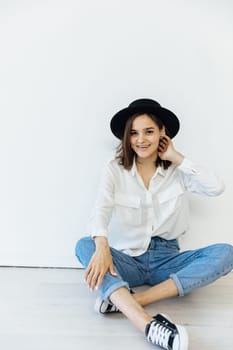 Woman in hat posing in studio