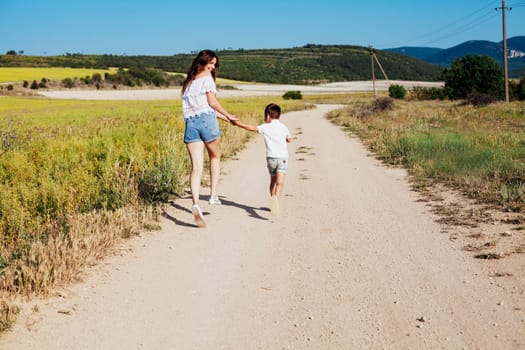 Mother and son walking along the road on a walk