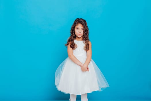 Girl in white dress on a blue background Holiday