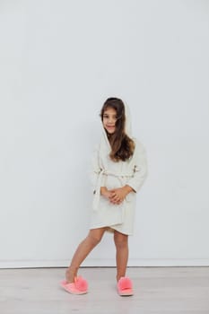 Girl in bathrobe in bright room white