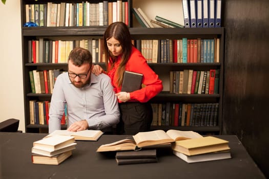 a man and a woman read a lot of books in the library 1